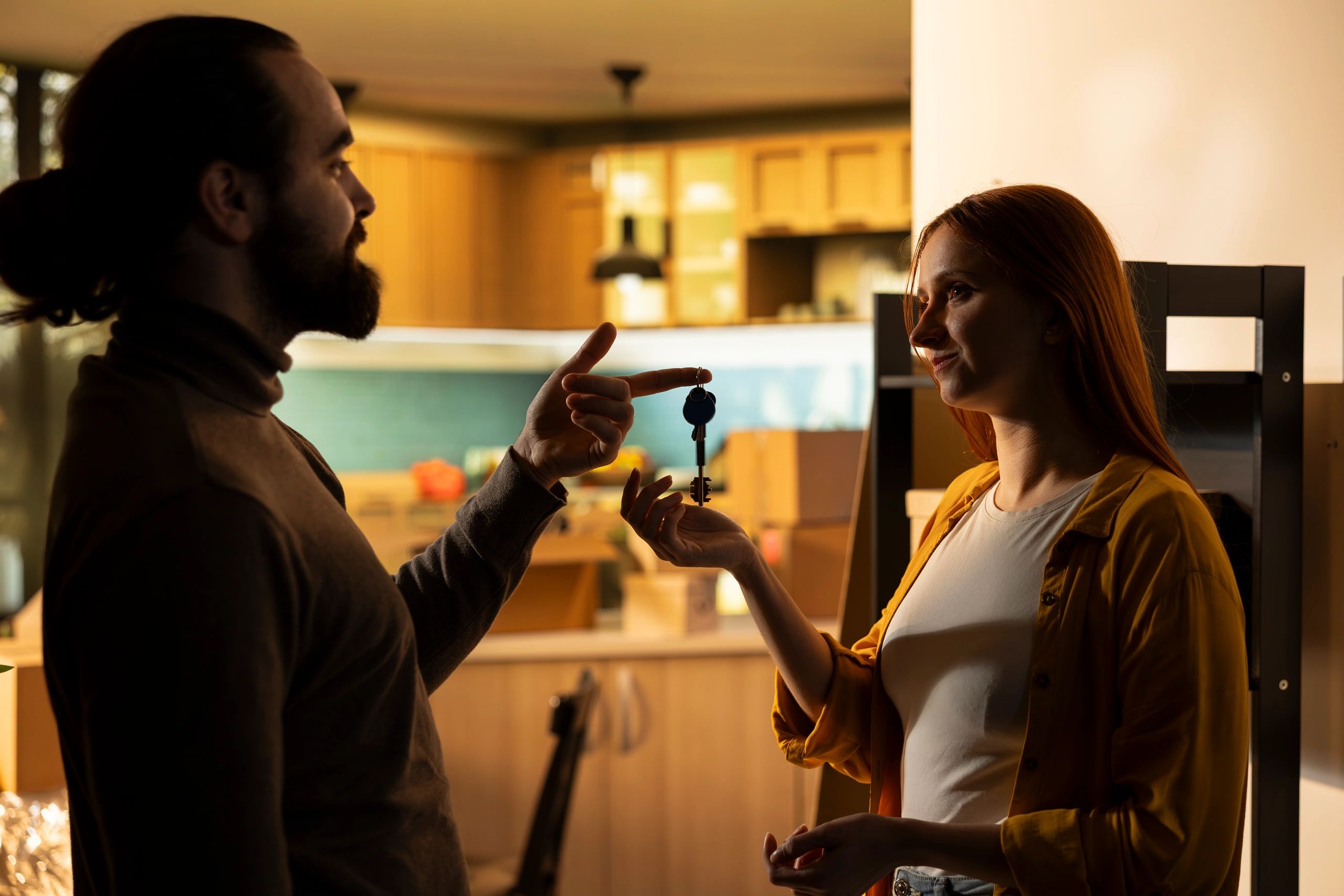 Couple holding house keys after buying a home
